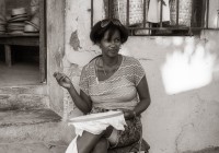 Cuban woman sewing in front of her shop