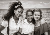 Three school girls on the Malacon in Havana Cuba