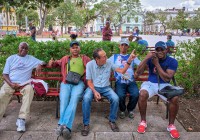 Men on park bench in Parque Vidal in Santa Clara Cuba