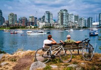 Local Bicylists resting and enjoying the view of False Creek in Vancouver