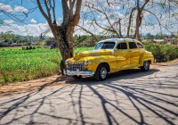 yellow-classic-dodge-automobile-parked-alongside-field-of-tabacco-in-vi%c3%b1ales
